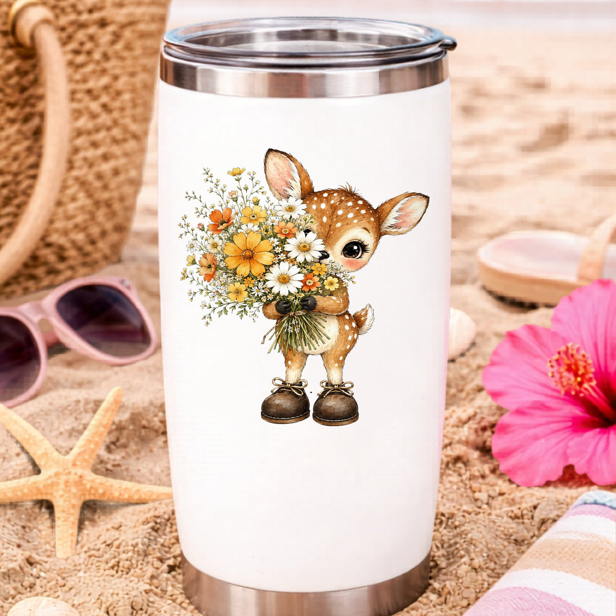 Baby Deer Holding Wildflower Bouquet UV DTF sticker applied to a white travel tumbler on beach sand