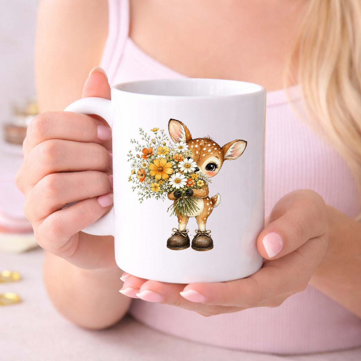 Baby Deer Holding Wildflower Bouquet UV DTF sticker applied to a white coffee mug held in both hands