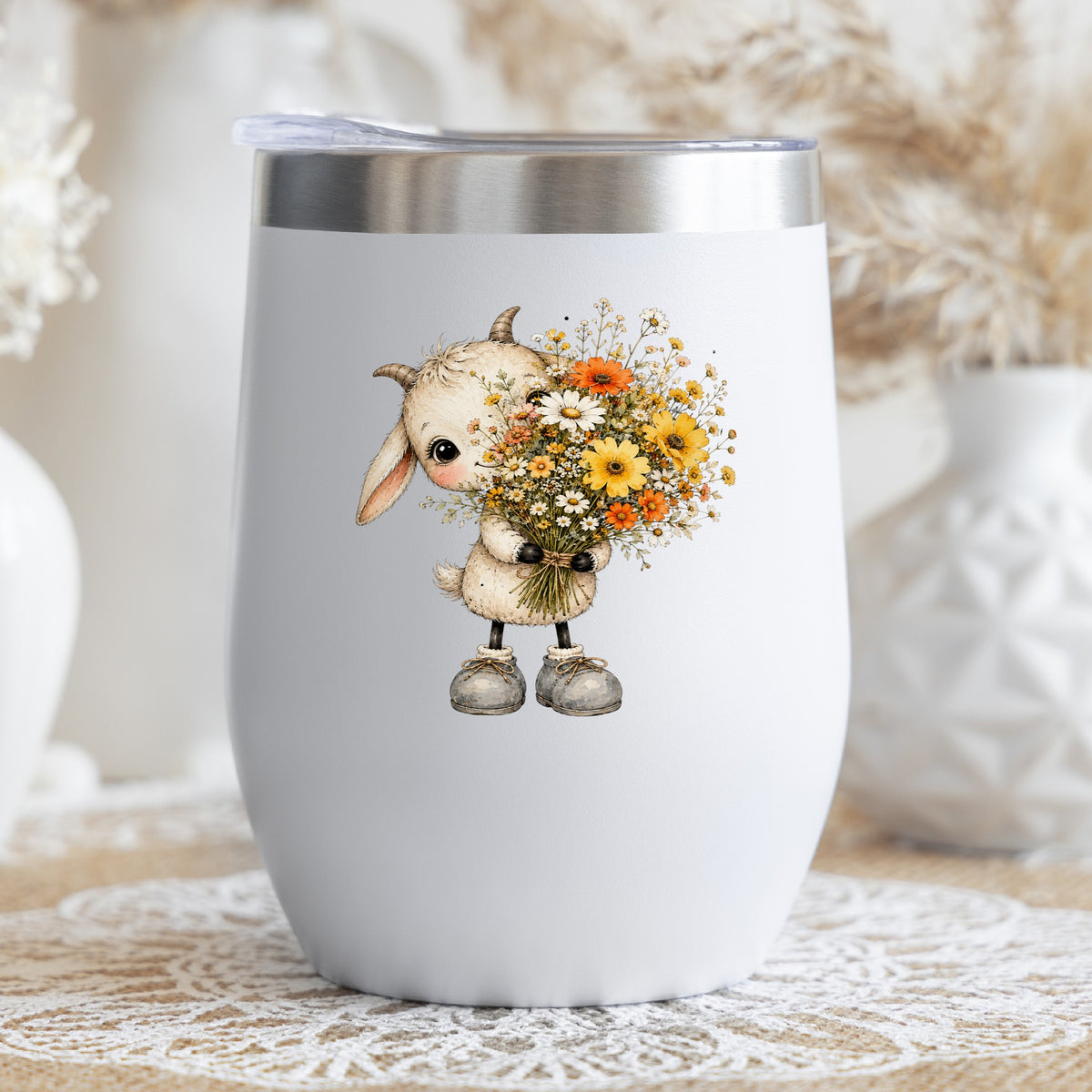 Baby Goat Holding Wildflower Bouquet UV DTF sticker applied to a white stemless tumbler with a lid