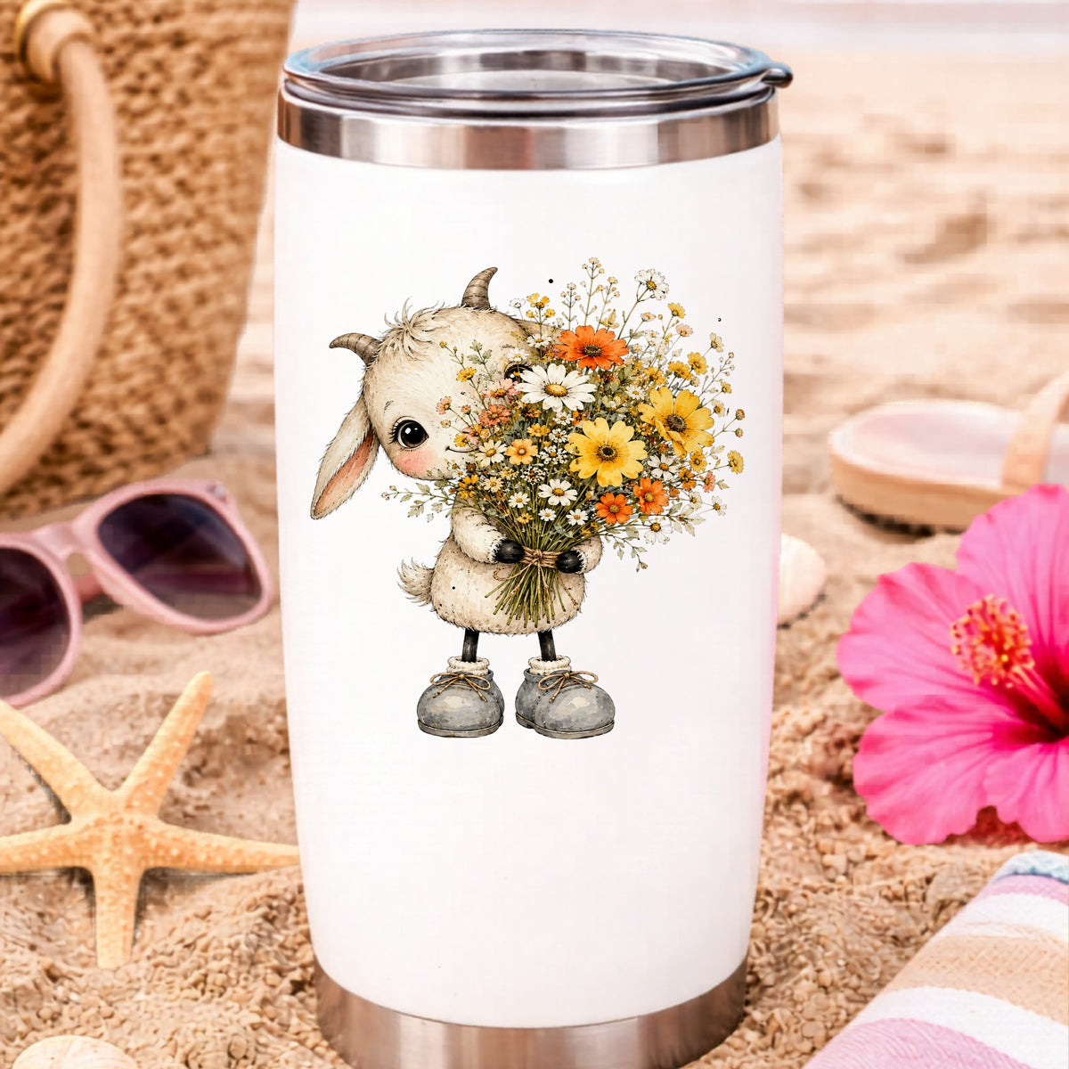 Baby Goat Holding Wildflower Bouquet UV DTF sticker applied to a white travel tumbler on beach sand