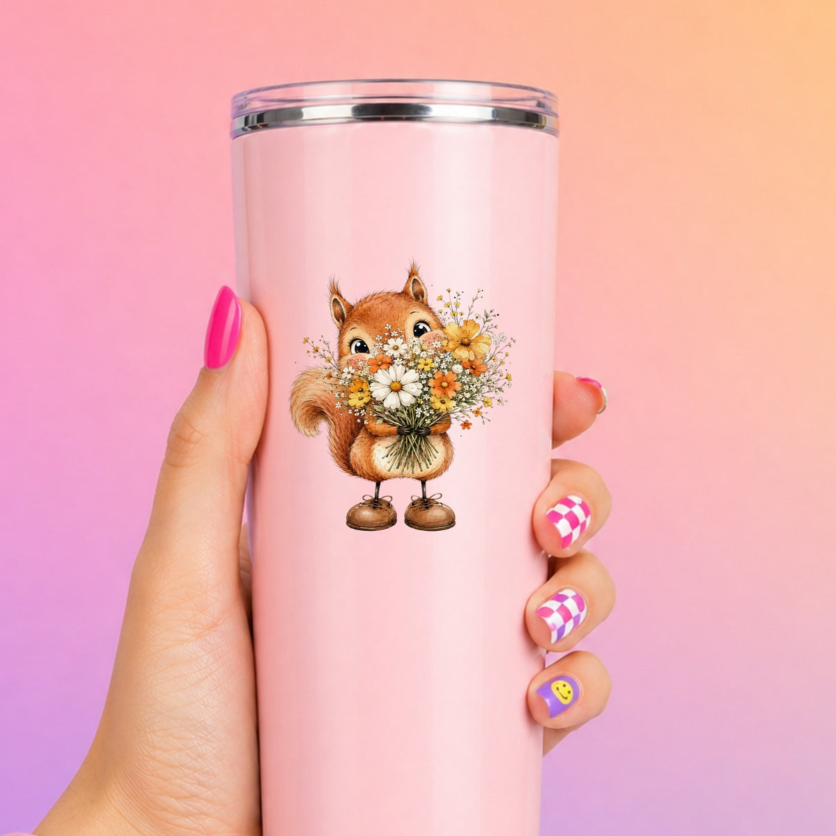 Red Squirrel Holding Daisy Bouquet UV DTF sticker applied to a tall pink tumbler on a pink and orange background