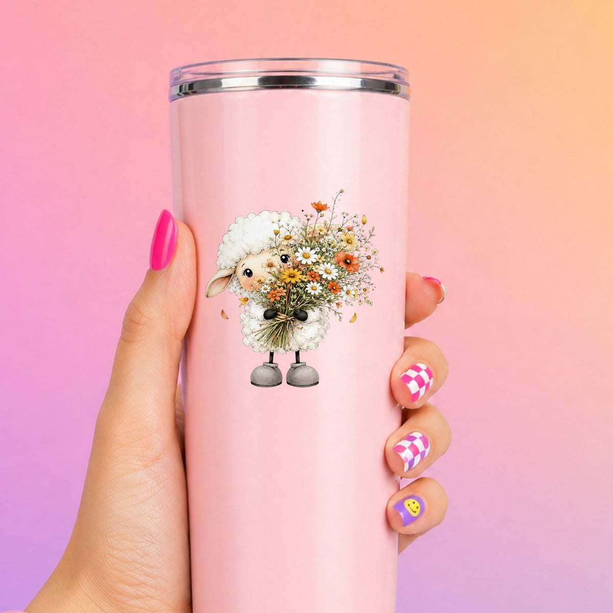 White Lamb Holding Wildflower Bouquet UV DTF sticker applied to a tall pink tumbler on a pink and orange background