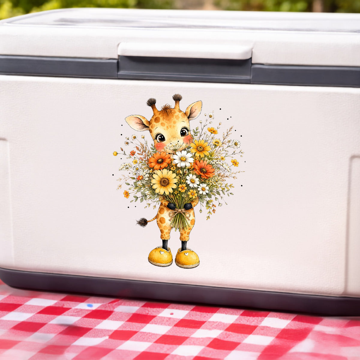 Watercolor Giraffe Holding Daisy Bouquet UV DTF sticker applied to a white cooler on a red gingham cloth