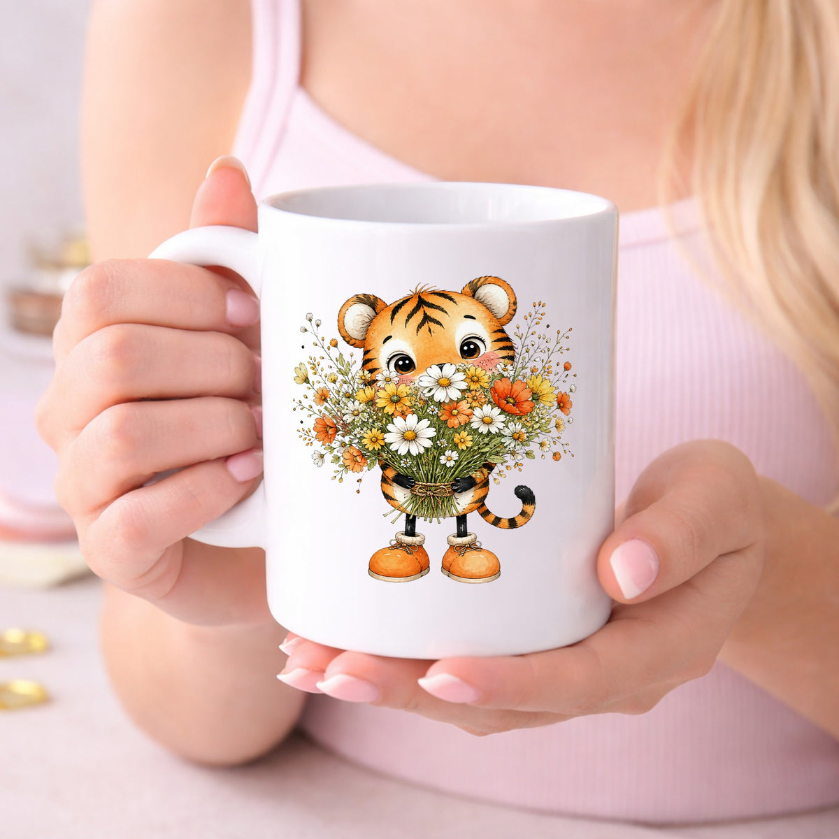 Tiger Cub Holding Wildflower Bouquet UV DTF sticker applied to a white coffee mug held in both hands