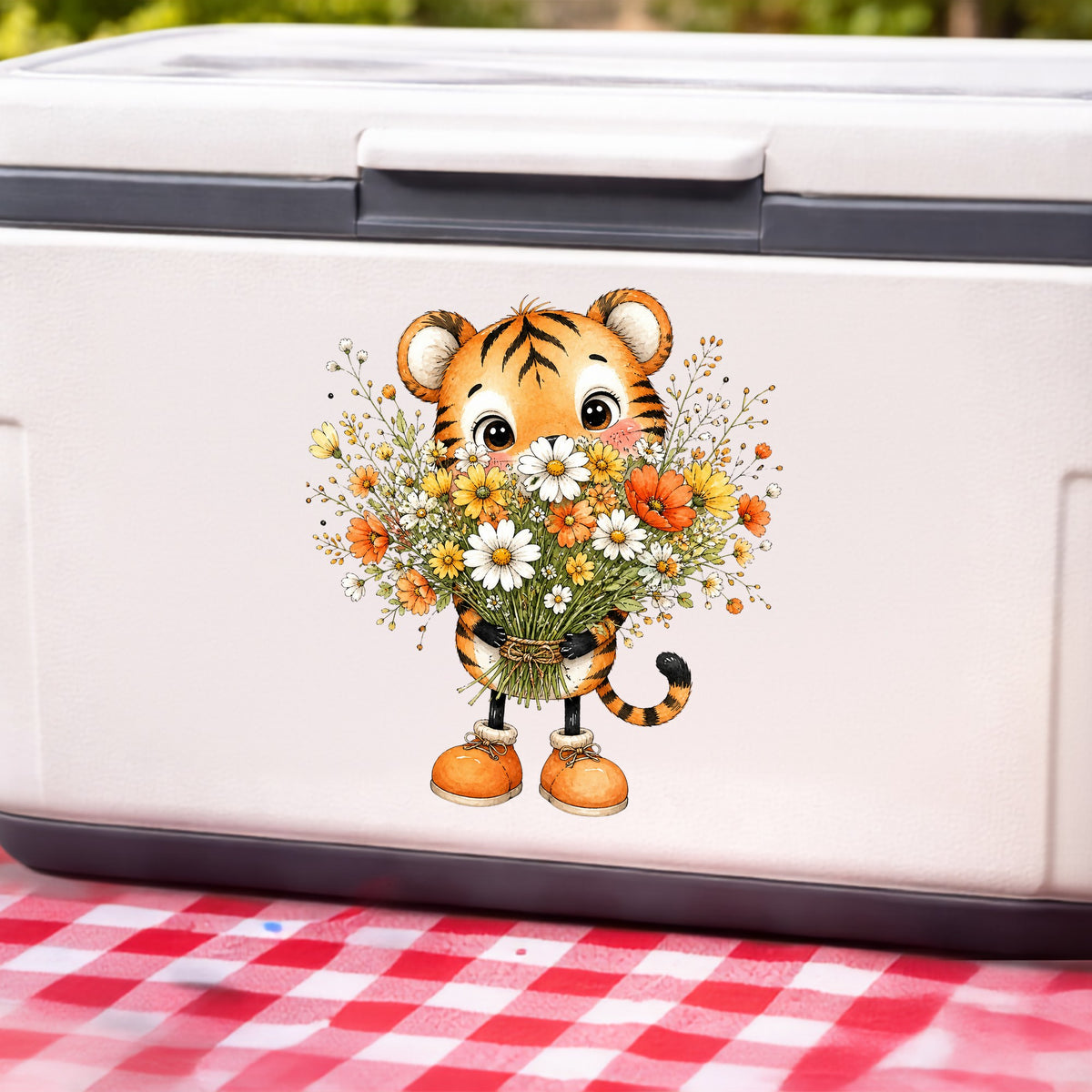 Tiger Cub Holding Wildflower Bouquet UV DTF sticker applied to a white cooler on a red gingham cloth