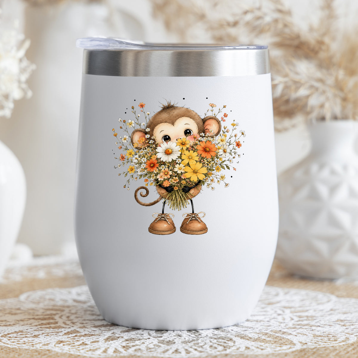 Baby Monkey Holding Daisy Bouquet UV DTF sticker applied to a white stemless tumbler with a lid