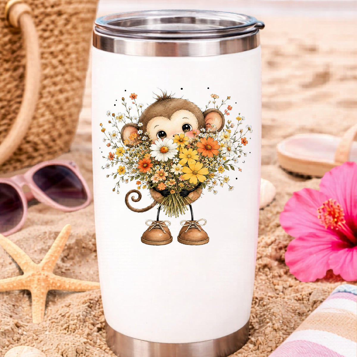 Baby Monkey Holding Daisy Bouquet UV DTF sticker applied to a white travel tumbler on beach sand