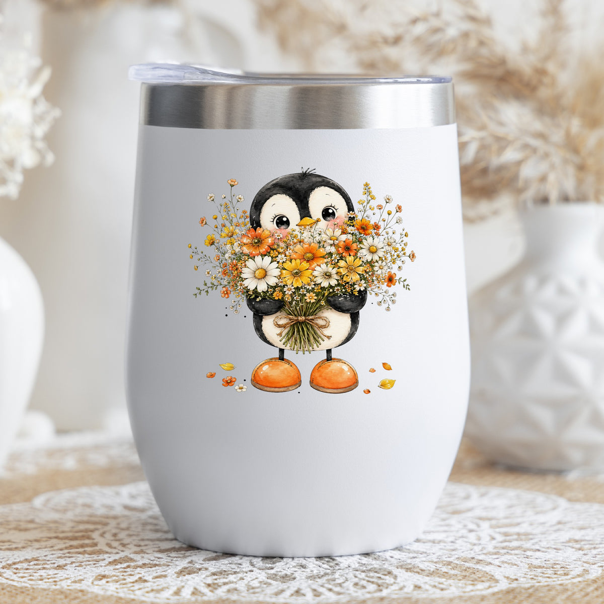 Baby Penguin Holding Wildflower Bouquet UV DTF sticker applied to a white stemless tumbler with a lid