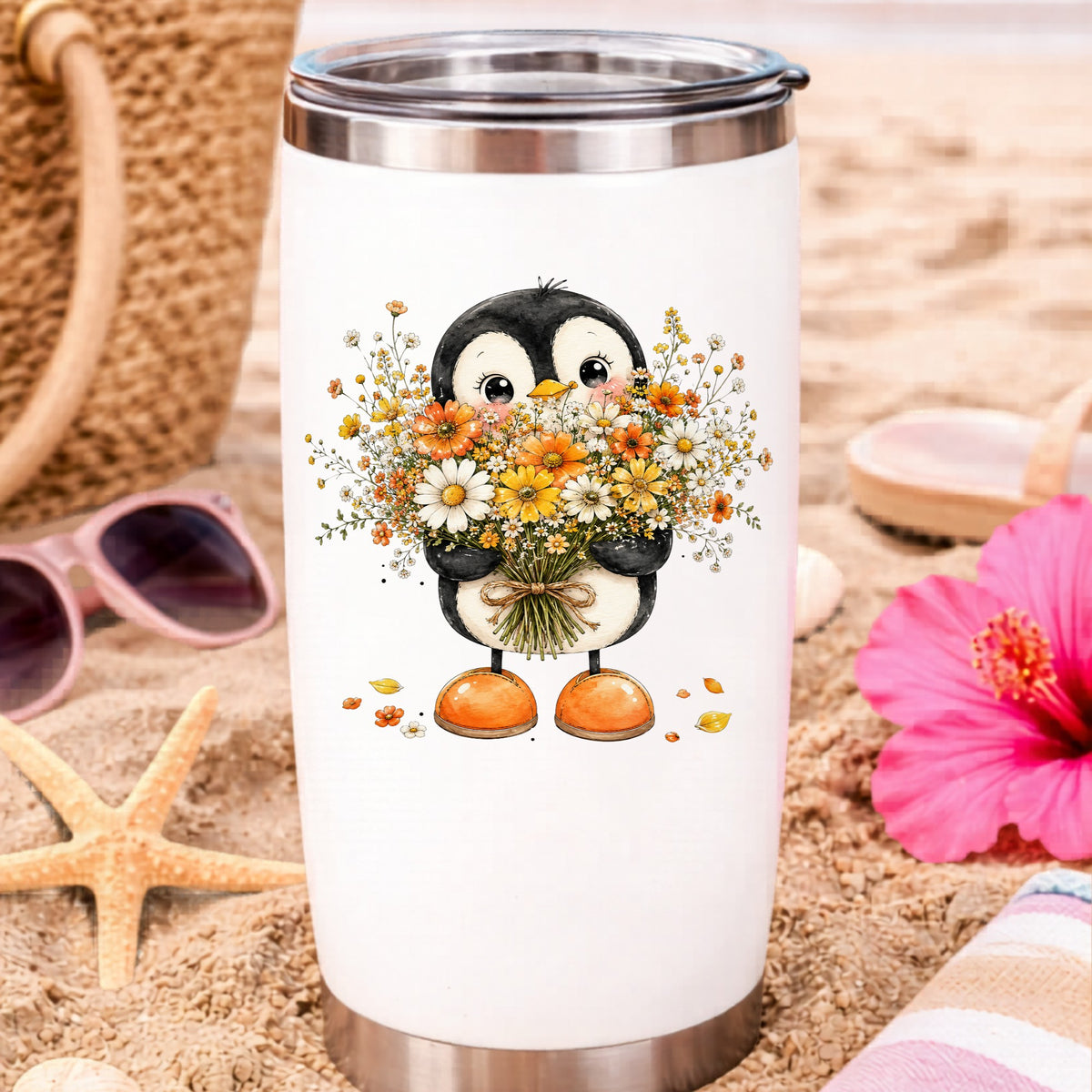 Baby Penguin Holding Wildflower Bouquet UV DTF sticker applied to a white travel tumbler on beach sand