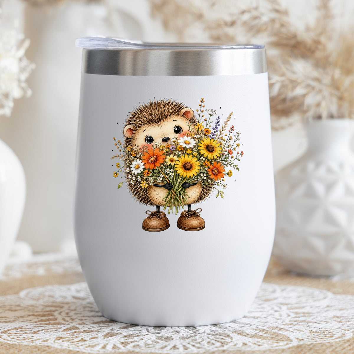 Hedgehog Holding Wildflower Bouquet UV DTF sticker applied to a white stemless tumbler with a lid