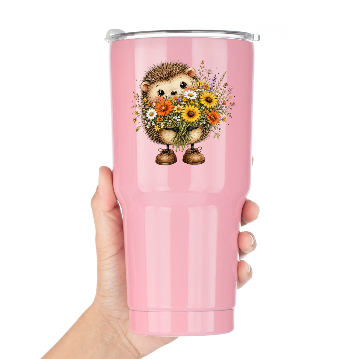 Hedgehog Holding Wildflower Bouquet UV DTF sticker applied to a pink tumbler held against a white background