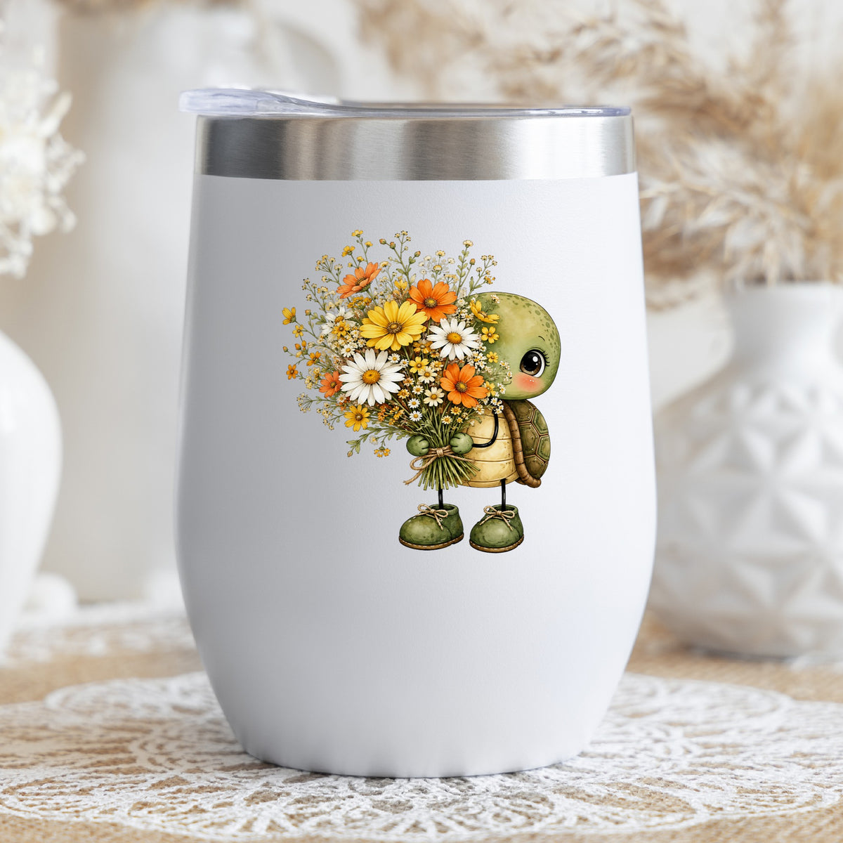 Baby Turtle Holding Wildflower Bouquet UV DTF sticker applied to a white stemless tumbler with a lid