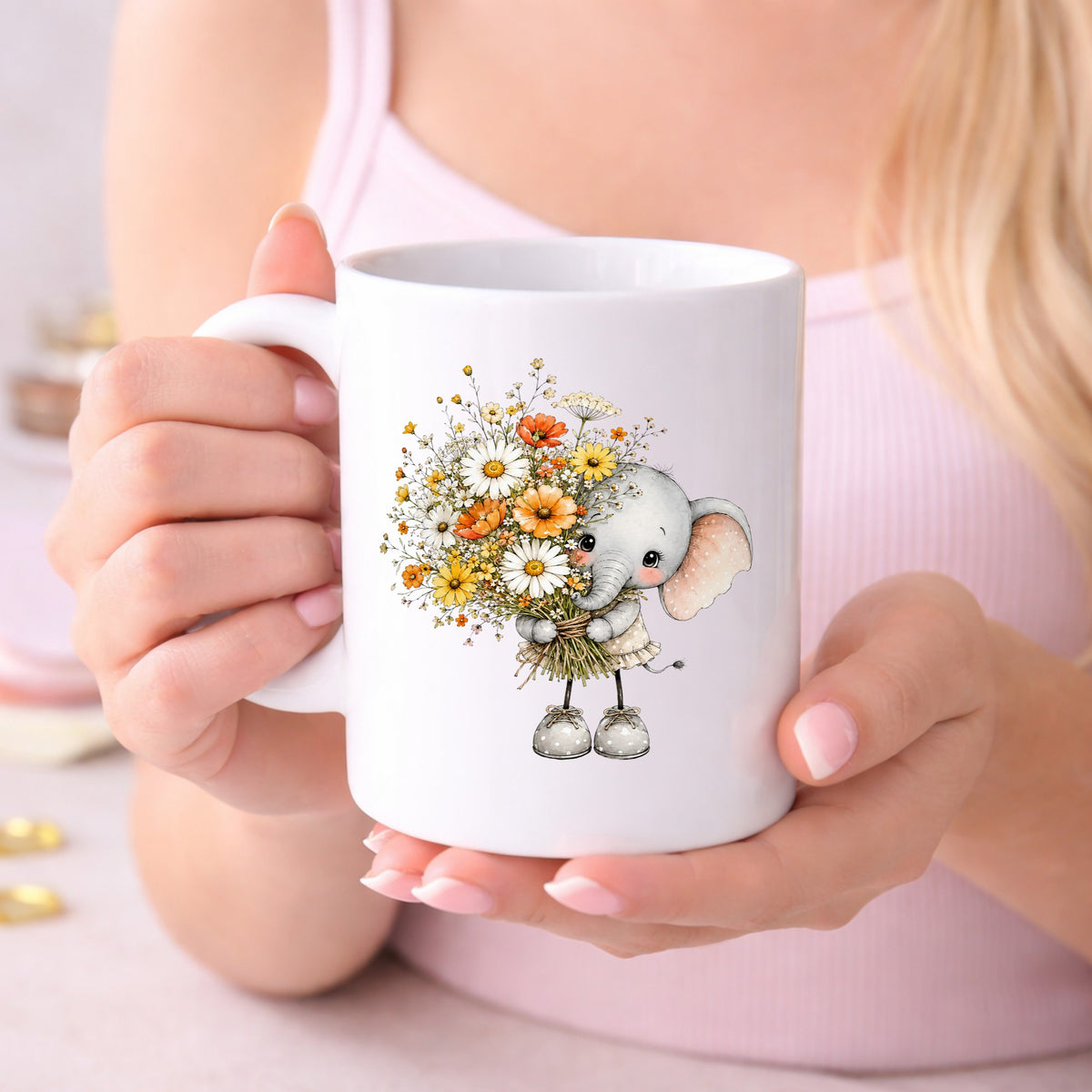 Baby Elephant Holding Daisy Bouquet UV DTF sticker applied to a white coffee mug held in both hands