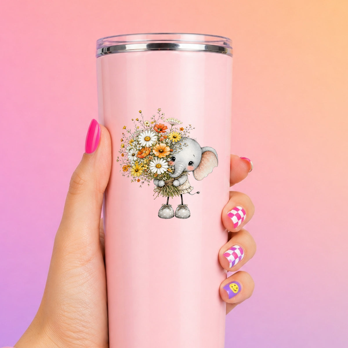 Baby Elephant Holding Daisy Bouquet UV DTF sticker applied to a tall pink tumbler on a pink and orange background