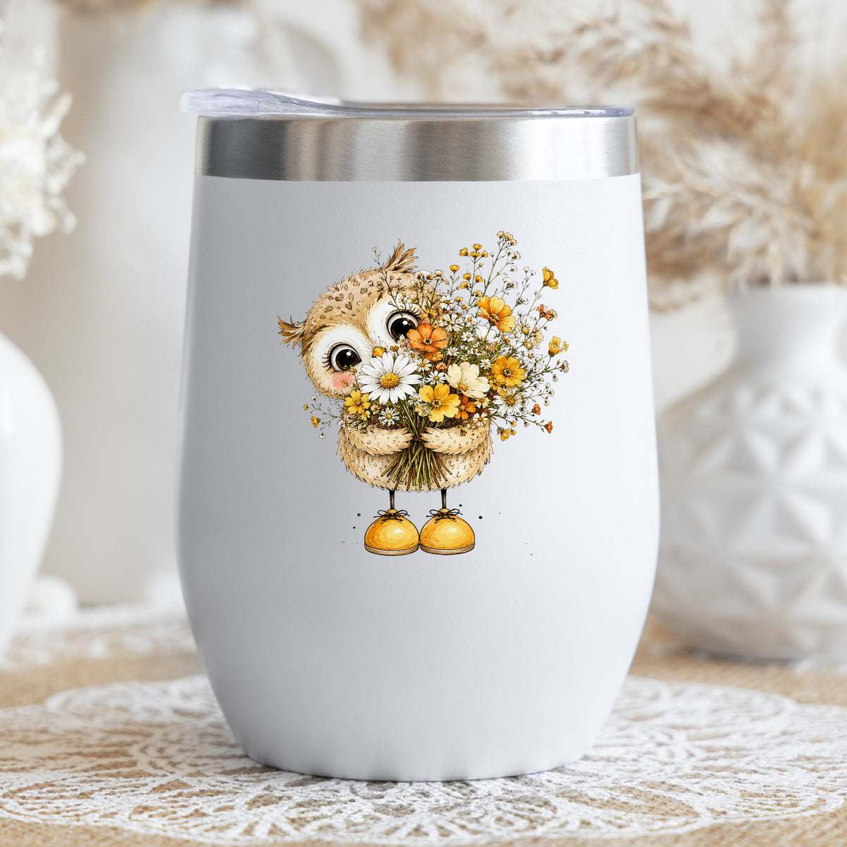 Baby Owl Holding Wildflower Bouquet UV DTF sticker applied to a white stemless tumbler with a lid