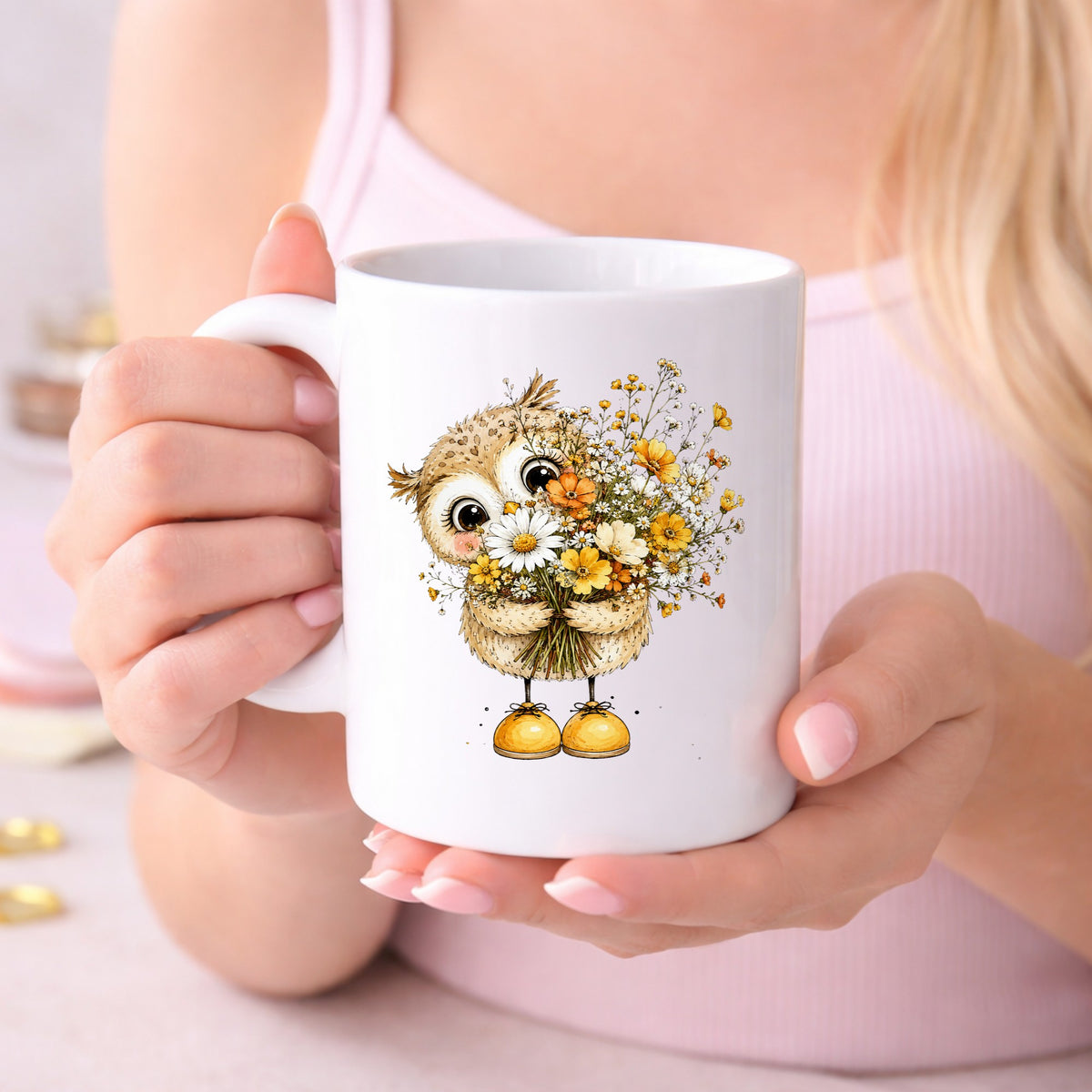 Baby Owl Holding Wildflower Bouquet UV DTF sticker applied to a white coffee mug held in both hands