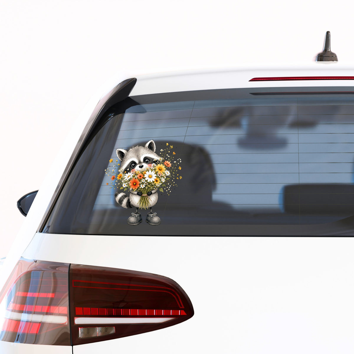 Raccoon Holding Wildflower Bouquet UV DTF sticker applied to the rear window of a white car