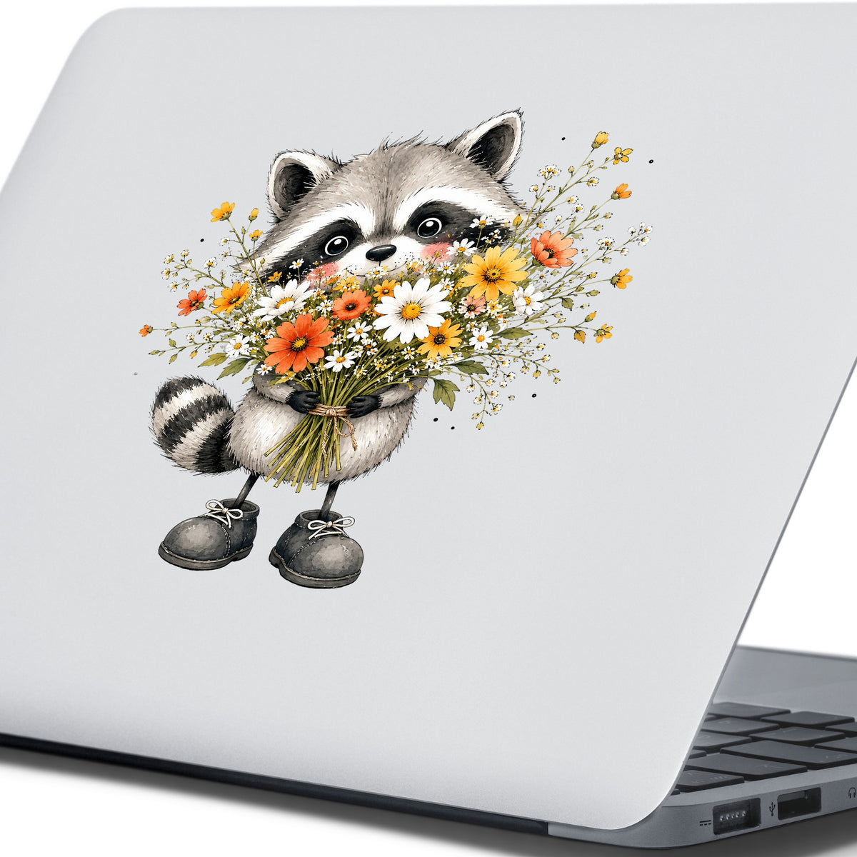Raccoon Holding Wildflower Bouquet UV DTF sticker applied to the lid of a silver laptop