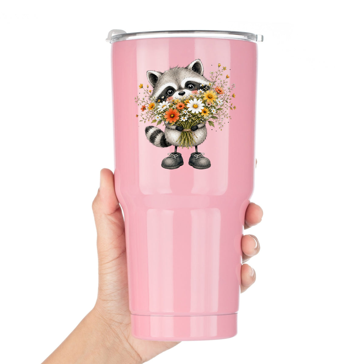 Raccoon Holding Wildflower Bouquet UV DTF sticker applied to a pink tumbler held against a white background