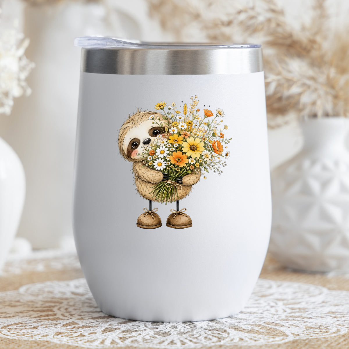Baby Sloth Holding Wildflower Bouquet UV DTF sticker applied to a white stemless tumbler with a lid