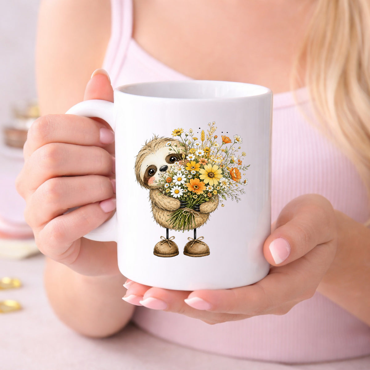 Baby Sloth Holding Wildflower Bouquet UV DTF sticker applied to a white coffee mug held in both hands