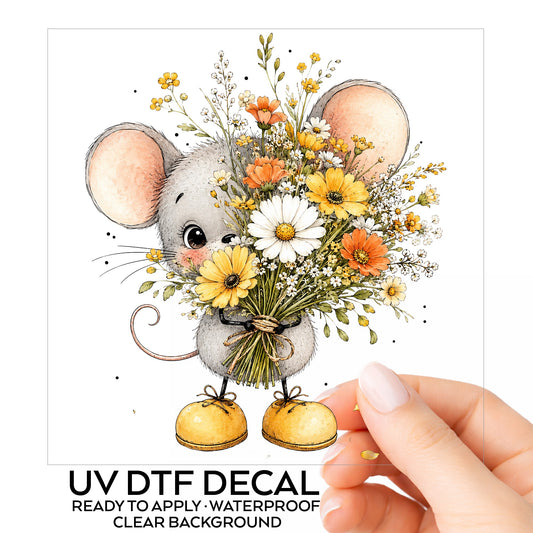 Little Mouse Holding Daisy Bouquet UV DTF sticker on its backing card, held in hand