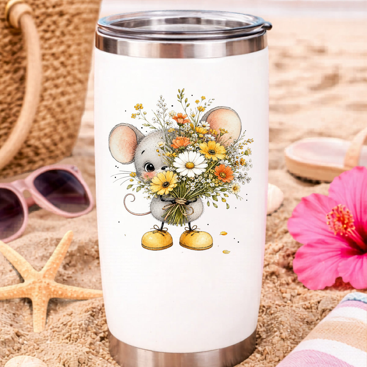 Little Mouse Holding Daisy Bouquet UV DTF sticker applied to a white travel tumbler on beach sand