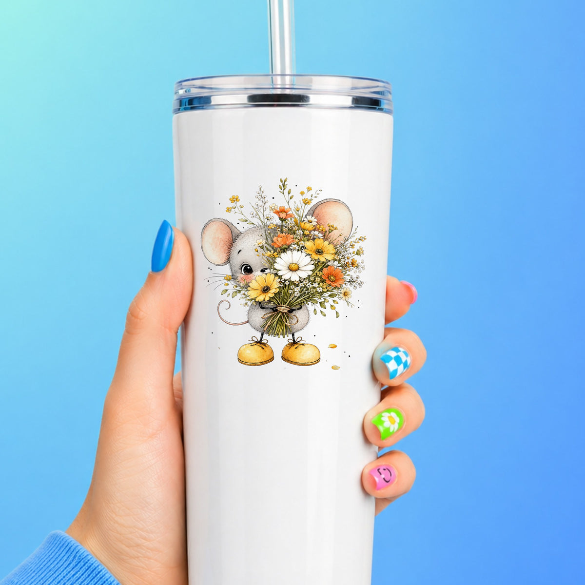 Little Mouse Holding Daisy Bouquet UV DTF sticker applied to a white straw tumbler on a blue background