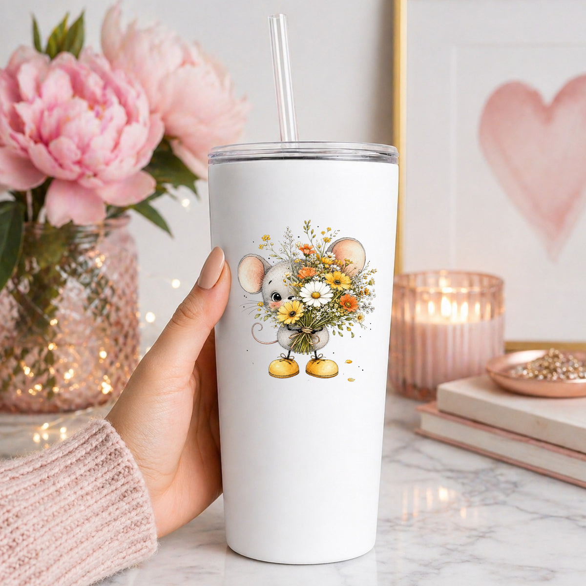 Little Mouse Holding Daisy Bouquet UV DTF sticker applied to a white straw tumbler beside pink peonies
