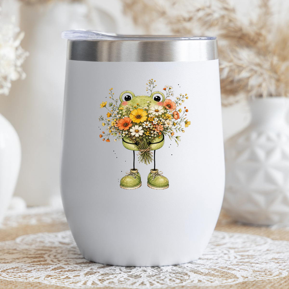 Green Frog Holding Wildflower Bouquet UV DTF sticker applied to a white stemless tumbler with a lid