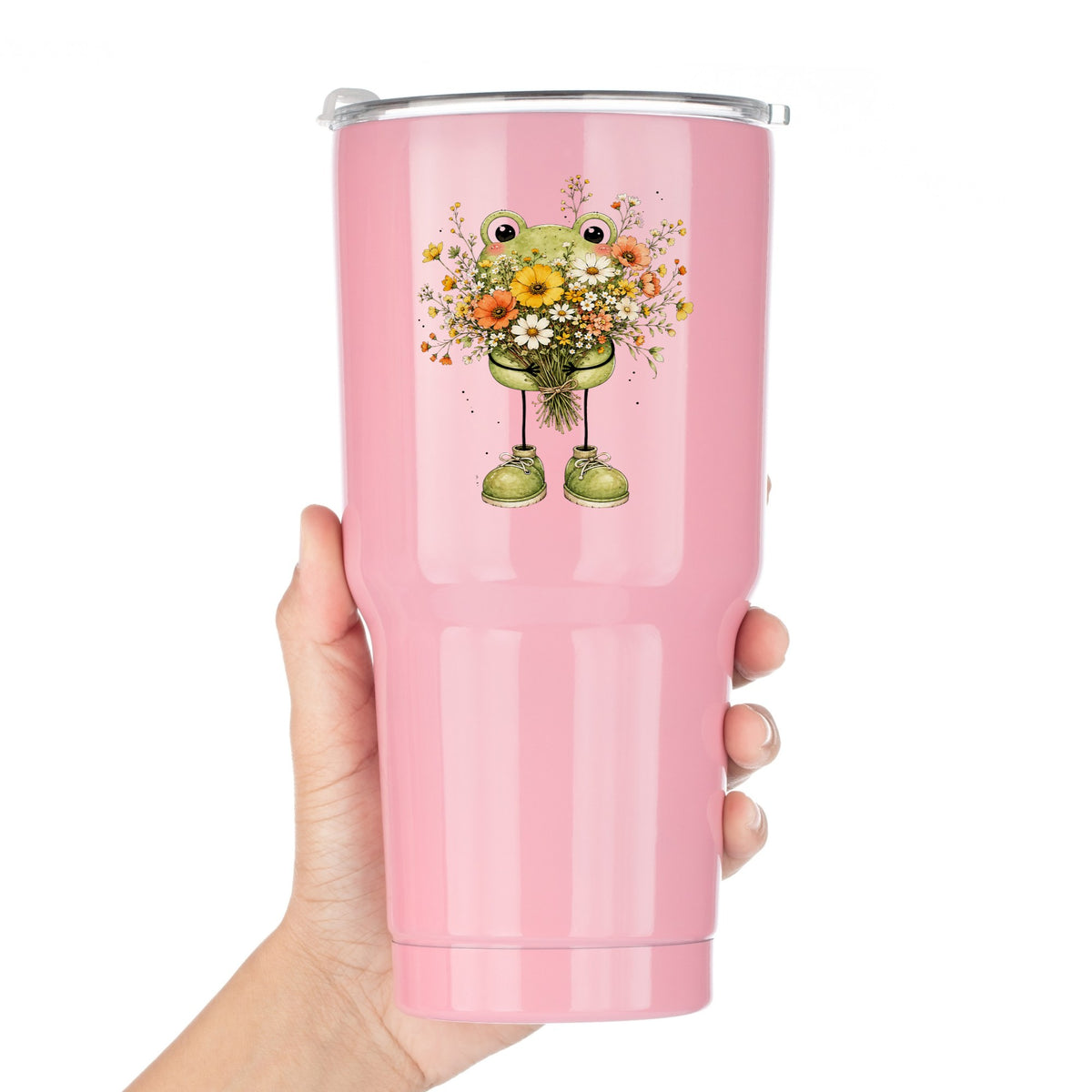Green Frog Holding Wildflower Bouquet UV DTF sticker applied to a pink tumbler held against a white background
