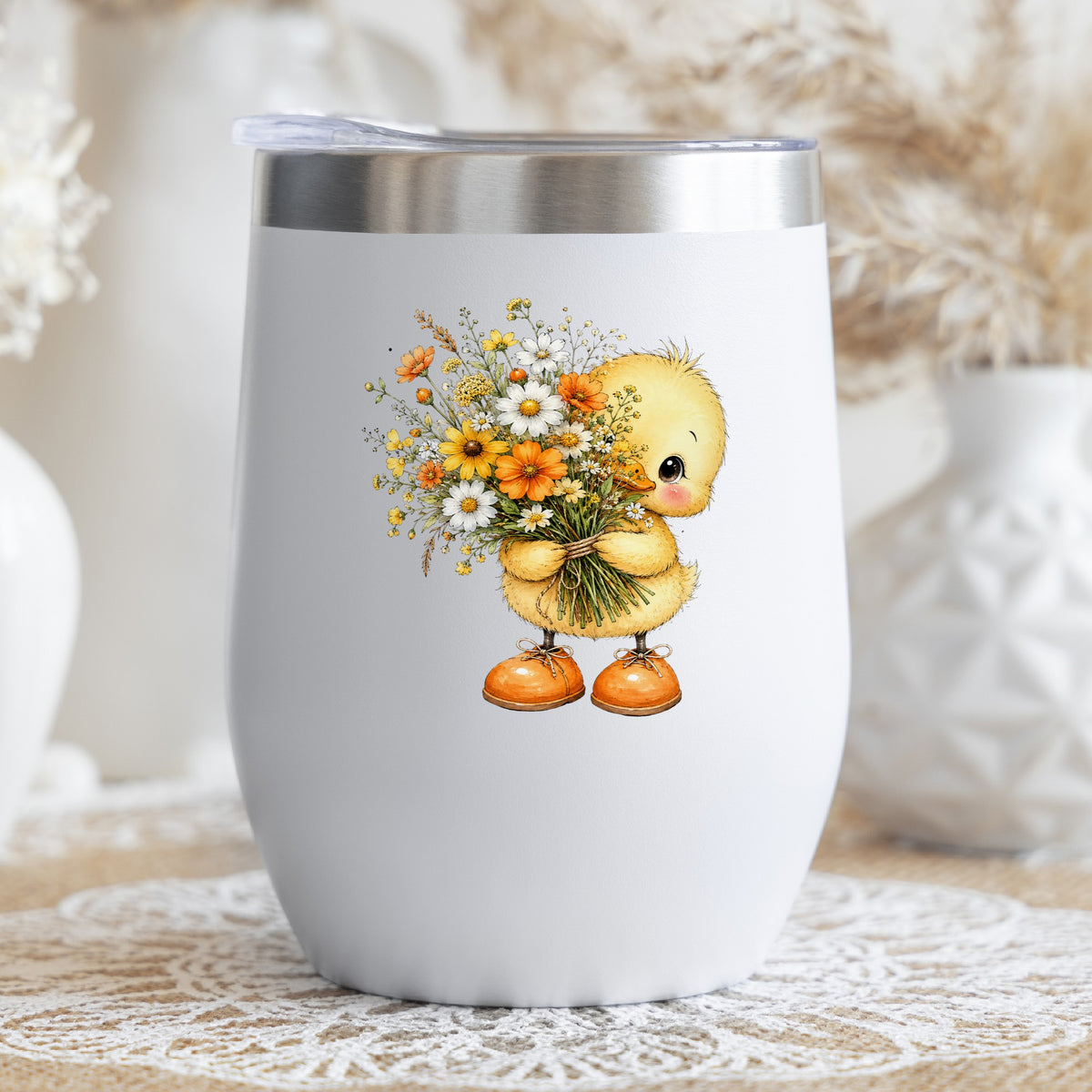 Yellow Duckling Holding Daisy Bouquet UV DTF sticker applied to a white stemless tumbler with a lid