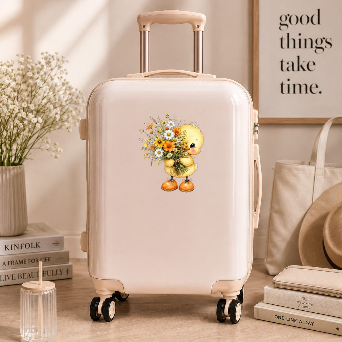 Yellow Duckling Holding Daisy Bouquet UV DTF sticker applied to a cream carry-on suitcase