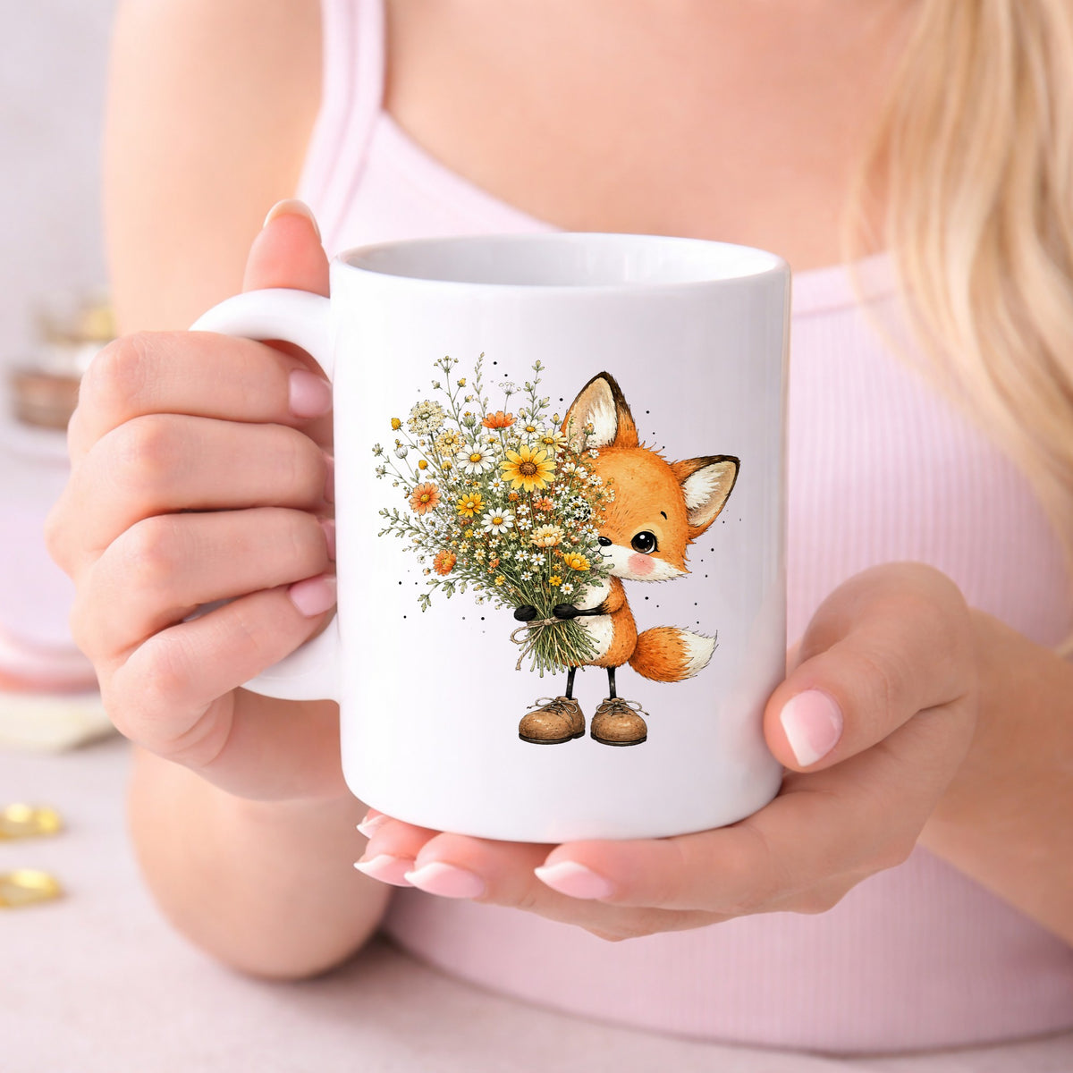Baby Fox Holding Wildflower Bouquet UV DTF sticker applied to a white coffee mug held in both hands