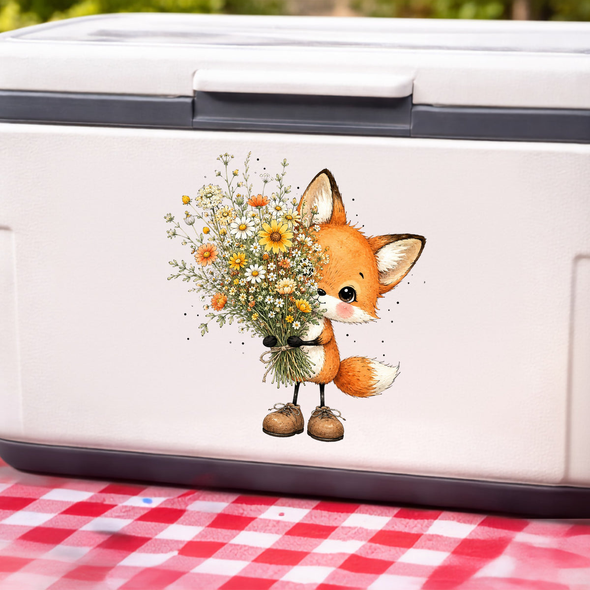 Baby Fox Holding Wildflower Bouquet UV DTF sticker applied to a white cooler on a red gingham cloth