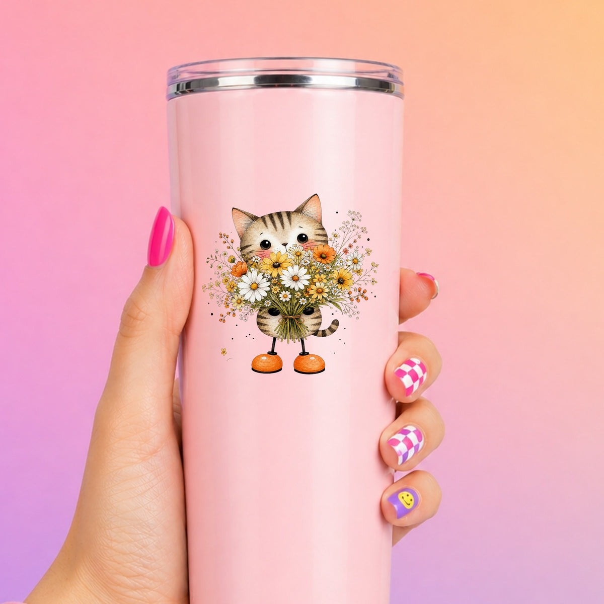 Tabby Cat Holding Daisy Bouquet UV DTF sticker applied to a tall pink tumbler on a pink and orange background