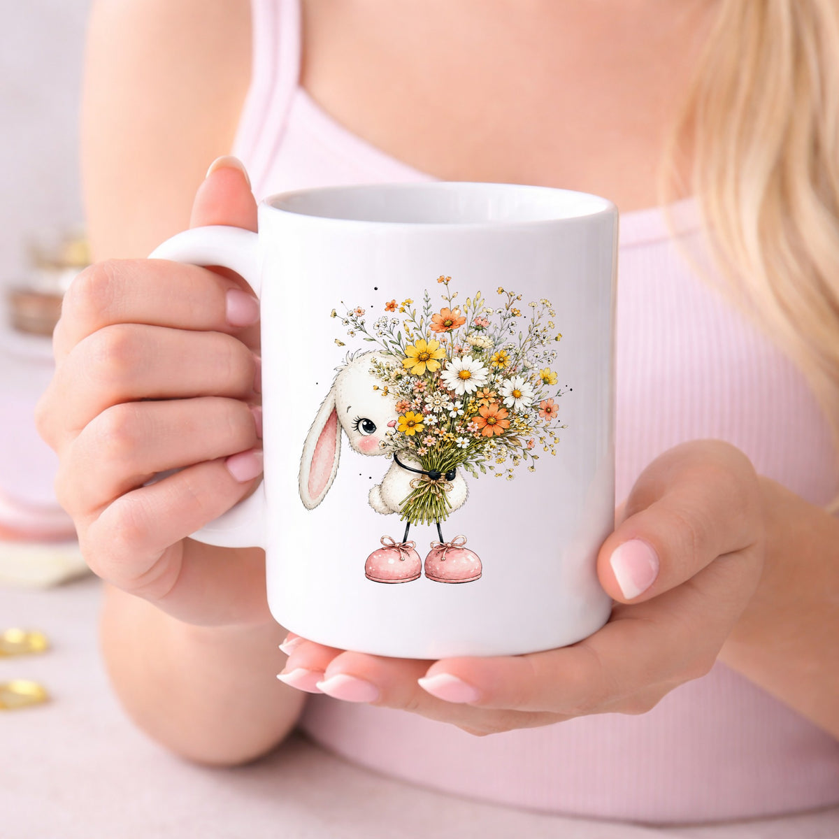 White Bunny Holding Wildflower Bouquet UV DTF sticker applied to a white coffee mug held in both hands