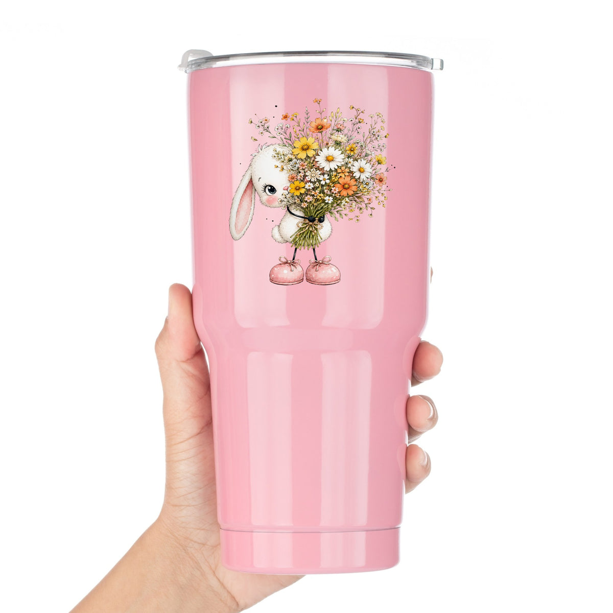 White Bunny Holding Wildflower Bouquet UV DTF sticker applied to a pink tumbler held against a white background