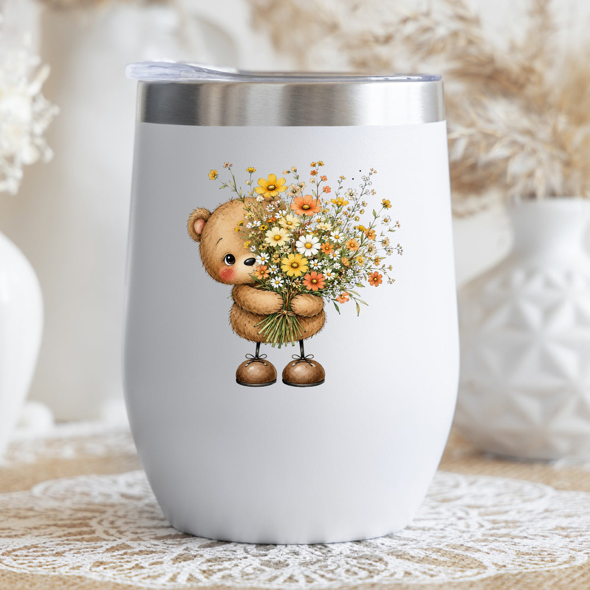 Teddy Bear Holding Wildflower Bouquet UV DTF sticker applied to a white stemless tumbler with a lid
