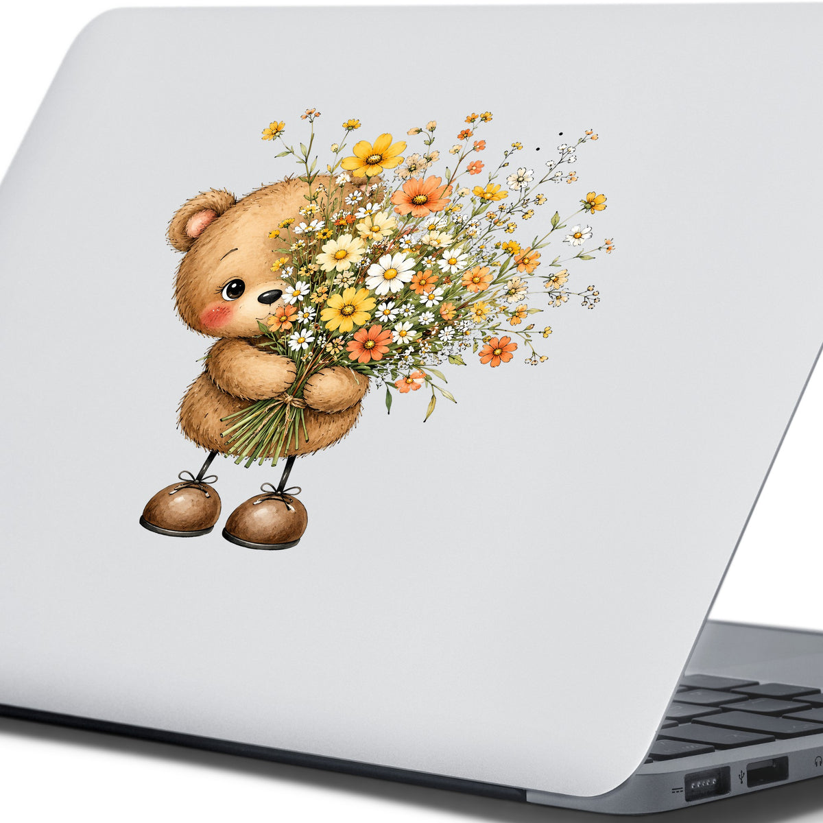 Teddy Bear Holding Wildflower Bouquet UV DTF sticker applied to the lid of a silver laptop