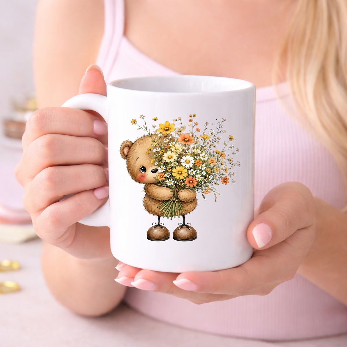 Teddy Bear Holding Wildflower Bouquet UV DTF sticker applied to a white coffee mug held in both hands