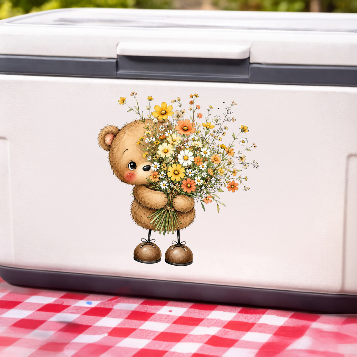 Teddy Bear Holding Wildflower Bouquet UV DTF sticker applied to a white cooler on a red gingham cloth