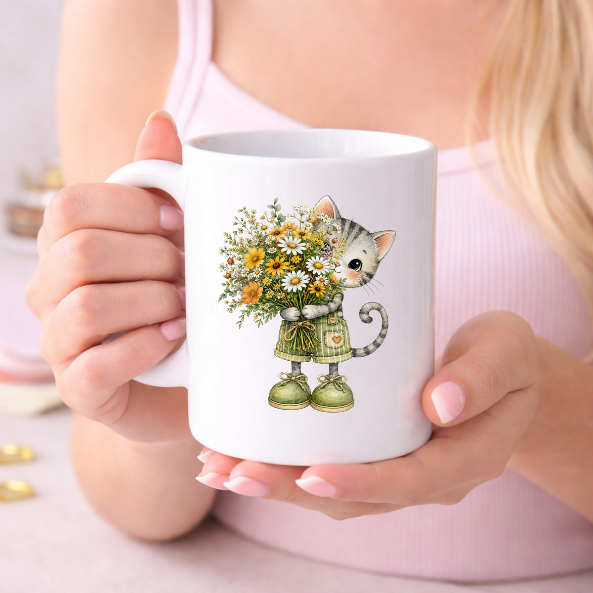 Grey Kitten In Overalls Holding Flowers UV DTF sticker applied to a white coffee mug held in both hands