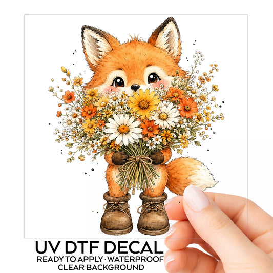 Watercolor Fox Holding Daisy Bouquet UV DTF sticker on its backing card, held in hand