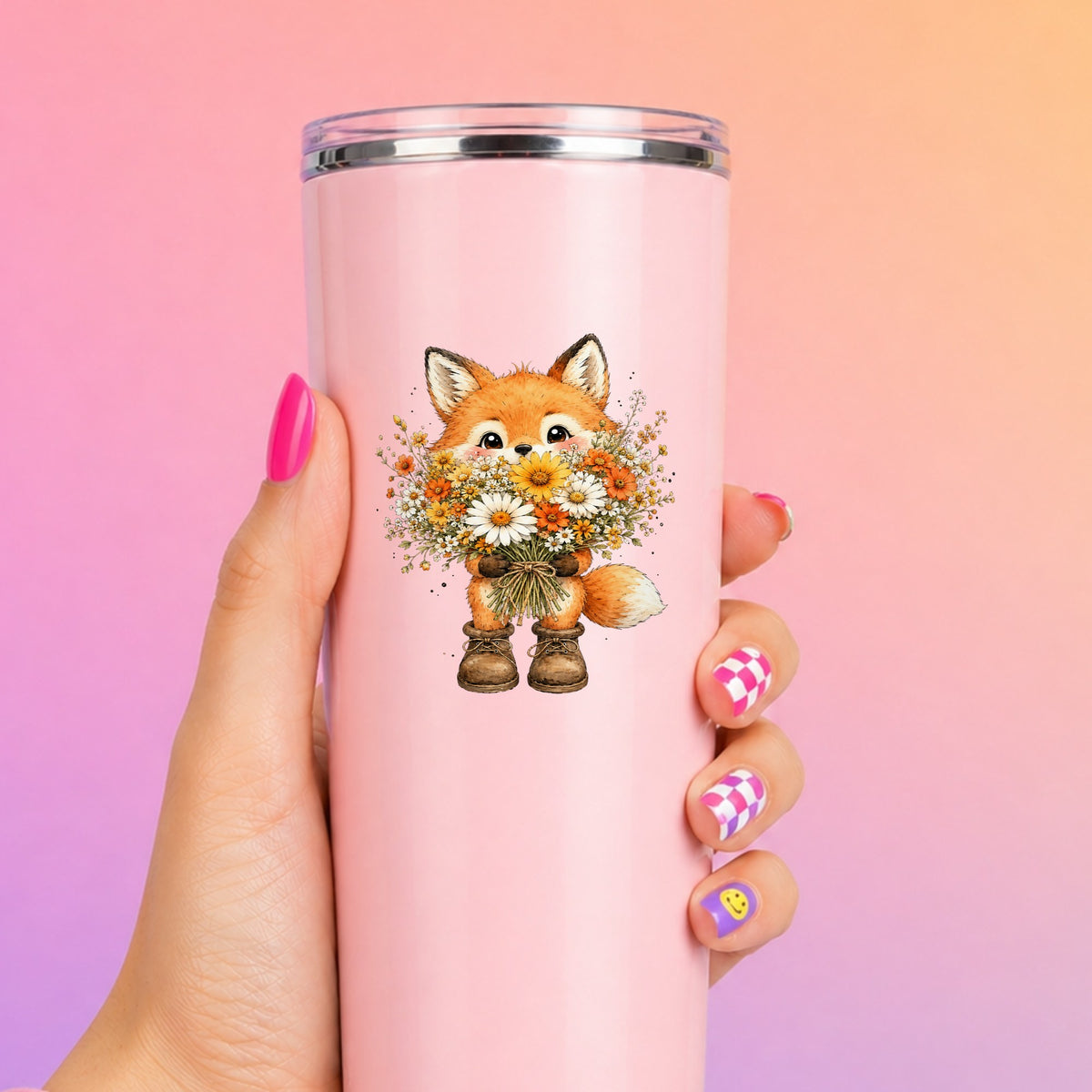 Watercolor Fox Holding Daisy Bouquet UV DTF sticker applied to a tall pink tumbler on a pink and orange background