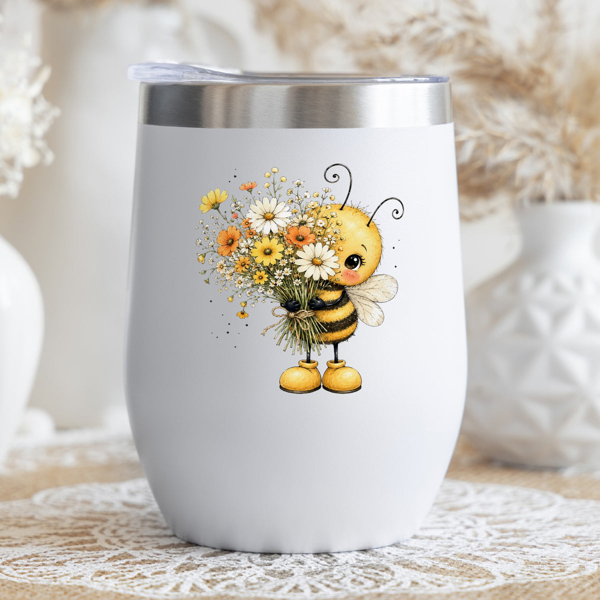 Honey Bee Holding Wildflower Bouquet UV DTF sticker applied to a white stemless tumbler with a lid