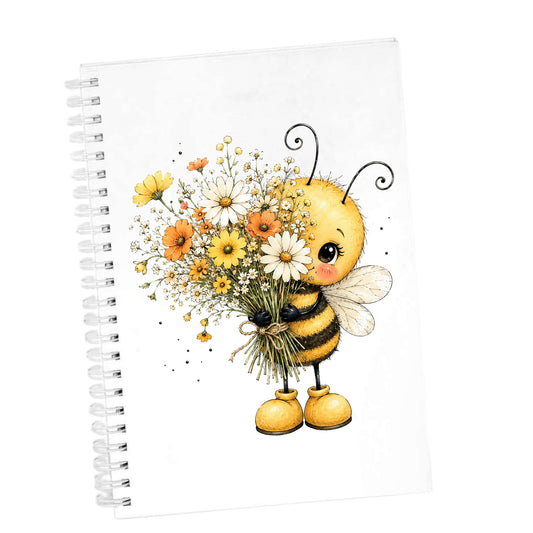 Honey Bee Holding Wildflower Bouquet UV DTF sticker applied to the cover of a white spiral journal