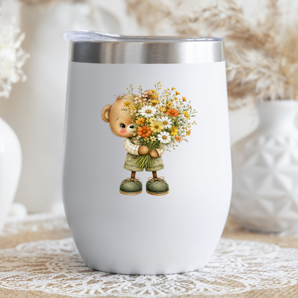 Brown Bear In Overalls Holding Daisy Bouquet UV DTF sticker applied to a white stemless tumbler with a lid