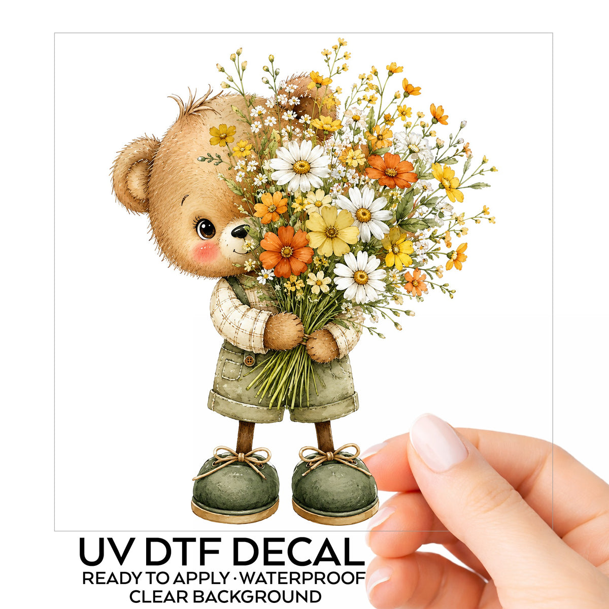 Brown Bear In Overalls Holding Daisy Bouquet UV DTF sticker on its backing card, held in hand