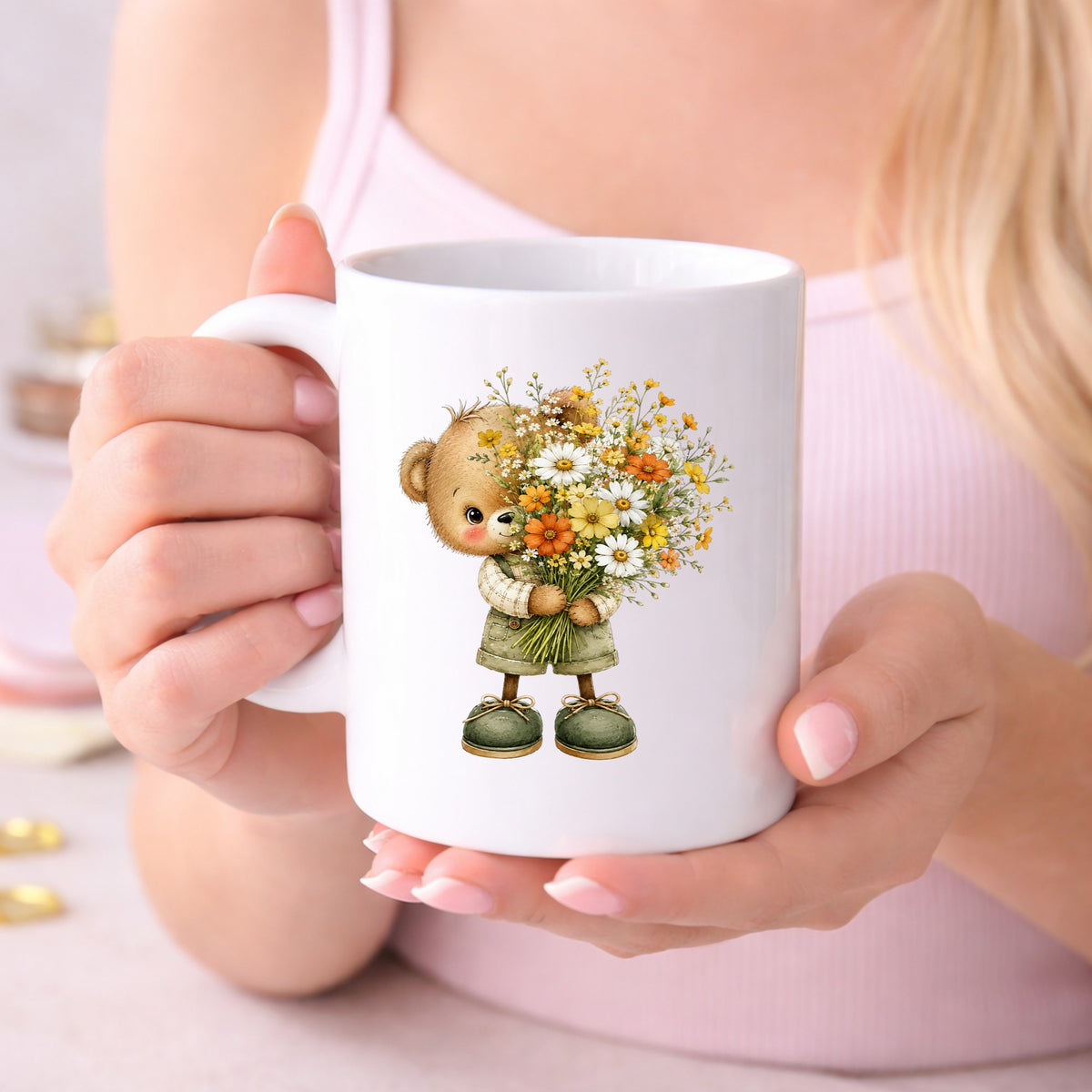 Brown Bear In Overalls Holding Daisy Bouquet UV DTF sticker applied to a white coffee mug held in both hands